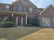 Charming two-story brick home featuring a two-car garage, covered entrance, and well-manicured landscaping at 1440 Gallup Dr, Stockbridge, GA 30281