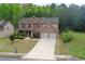 Charming two-story home with brick facade, two-car garage, and well-manicured lawn at 1440 Gallup Dr, Stockbridge, GA 30281