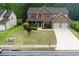 Two-story home with brick and siding, featuring a two-car garage and landscaped front yard at 1440 Gallup Dr, Stockbridge, GA 30281