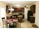 Eat-in kitchen with dark wood cabinets, granite countertops, and black appliances at 1440 Gallup Dr, Stockbridge, GA 30281