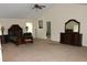 Large primary bedroom with vaulted ceilings, ceiling fan, and dark wood furniture at 1440 Gallup Dr, Stockbridge, GA 30281