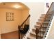 Carpeted staircase with dark wood banister, leading to the upper level of the home at 1440 Gallup Dr, Stockbridge, GA 30281