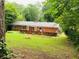 Large, green backyard with brick patio, offering privacy and room for recreation at 3727 Dial Dr, Stone Mountain, GA 30083