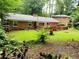 Green backyard with a brick patio, perfect for relaxing and entertaining guests at 3727 Dial Dr, Stone Mountain, GA 30083