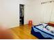 A view of the bedroom, showing the closet and wooden flooring at 3727 Dial Dr, Stone Mountain, GA 30083