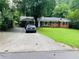 Charming brick ranch home featuring a well-maintained lawn and spacious driveway at 3727 Dial Dr, Stone Mountain, GA 30083