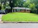 Inviting one-story brick home with lush green lawn and mature trees in a quiet neighborhood at 3727 Dial Dr, Stone Mountain, GA 30083