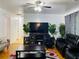 Inviting living room with hardwood floors, a dark entertainment center, and modern gray accents at 3727 Dial Dr, Stone Mountain, GA 30083