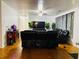 Spacious living room featuring gleaming hardwood floors, neutral walls, and comfortable black leather seating at 3727 Dial Dr, Stone Mountain, GA 30083