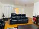 A well-lit living room featuring hardwood floors, comfortable black seating, and a bright doorway at 3727 Dial Dr, Stone Mountain, GA 30083