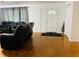 Inviting living room with hardwood floors, comfortable seating, and a view of the front door and entryway at 3727 Dial Dr, Stone Mountain, GA 30083