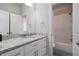 Bathroom showcasing granite counters, white cabinetry, and a shower-tub combination with white subway tile surround at 4402 Income Cir, Ellenwood, GA 30294