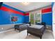 bedroom featuring twin beds, large window, and vibrant paint scheme with an action hero theme at 4402 Income Cir, Ellenwood, GA 30294