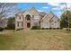 Stately two-story brick home featuring arched windows and manicured front lawn at 4402 Income Cir, Ellenwood, GA 30294