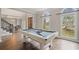 Game room with pool table and views into the formal dining room at 4402 Income Cir, Ellenwood, GA 30294