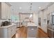 Bright kitchen features stainless appliances, granite countertops and hardwood floors at 4402 Income Cir, Ellenwood, GA 30294