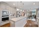 Bright kitchen with stainless appliances, island, and sightlines to Gathering room at 4402 Income Cir, Ellenwood, GA 30294