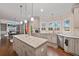 Stylish kitchen with island, granite countertops, and stainless steel appliances at 4402 Income Cir, Ellenwood, GA 30294