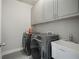 Modern laundry room with washer, dryer, sink and storage at 4402 Income Cir, Ellenwood, GA 30294
