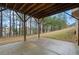 View of a concrete patio with a wooded backyard, creating a tranquil outdoor space with privacy at 4402 Income Cir, Ellenwood, GA 30294