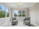 Bright sitting room features many windows and plush armchairs at 4402 Income Cir, Ellenwood, GA 30294
