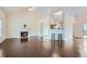 Bright living room with high ceilings, hardwood floors, fireplace, and open access to the kitchen at 5997 Tate Dr, Austell, GA 30106