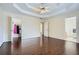 Spacious main bedroom with trey ceilings, dark hardwood floors, and access to the walk-in closet at 5997 Tate Dr, Austell, GA 30106