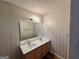 Bathroom featuring a double sink vanity with a large mirror and modern lighting fixtures, providing ample space at 709 Kilkenny Cir, Lithonia, GA 30058
