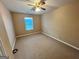 Bedroom with neutral walls, carpet, and a window allowing natural light, providing a cozy retreat at 709 Kilkenny Cir, Lithonia, GA 30058