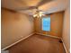 This cozy bedroom has carpet floors, a ceiling fan with lights, and a window with blinds at 709 Kilkenny Cir, Lithonia, GA 30058