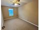 Bedroom with neutral carpet, window, and ceiling fan at 709 Kilkenny Cir, Lithonia, GA 30058
