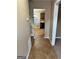 Hallway featuring neutral paint, tile flooring, and views to the kitchen, leading to other areas at 709 Kilkenny Cir, Lithonia, GA 30058