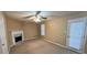 Living room with ceiling fan, fireplace, and door to the exterior at 709 Kilkenny Cir, Lithonia, GA 30058