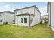 Newly seeded backyard features plush green grass and the home's light-colored siding at 2771 Aralynn Way, College Park, GA 30337