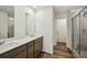 Bathroom features double sinks, dark wood cabinets, vinyl floors, and a walk-in shower at 2771 Aralynn Way, College Park, GA 30337