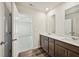 Bathroom boasts double sinks, wood cabinets, white countertops, and modern fixtures at 2771 Aralynn Way, College Park, GA 30337