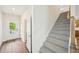 Bright foyer with hardwood floors, featuring a stairway leading upstairs and a glimpse of the kitchen at 2771 Aralynn Way, College Park, GA 30337