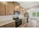 Kitchen area featuring stainless steel appliances, granite counters, and wooden cabinets at 2771 Aralynn Way, College Park, GA 30337