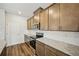 Kitchen featuring granite counters, subway tile backsplash, stainless steel appliances, and wooden cabinets at 2771 Aralynn Way, College Park, GA 30337