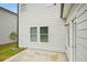 Concrete patio of a new home, showing siding, outdoor lighting, and small yard at 2771 Aralynn Way, College Park, GA 30337