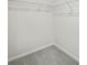 Small walk-in closet features basic wire shelving and neutral gray carpet at 2771 Aralynn Way, College Park, GA 30337