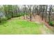 Expansive backyard with lush green grass and mature trees, providing a serene outdoor space at 300 Outlaw Rdg, Canton, GA 30115