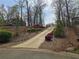 Long, private driveway leading to the property, adorned with lush landscaping and mature trees at 300 Outlaw Rdg, Canton, GA 30115