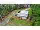 Aerial view of a house with outbuilding, offering a blend of residential comfort and functional workspace at 300 Outlaw Rdg, Canton, GA 30115