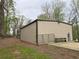 A metal workshop/garage sits to the back of the lot surrounded by woods at 300 Outlaw Rdg, Canton, GA 30115