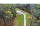 Metal outbuilding with concrete driveway surrounded by trees, offering versatile space and rural charm at 300 Outlaw Rdg, Canton, GA 30115