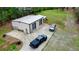 Exterior aerial view of a metal outbuilding with roll-up doors and ample parking space at 300 Outlaw Rdg, Canton, GA 30115