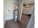 A well-lit utility room featuring a modern water heater and clean, neutral walls and flooring at 300 Outlaw Rdg, Canton, GA 30115