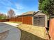 Fenced backyard featuring a storage shed, concrete patio, and lush grassy area at 2910 Blake Towers Ln, Buford, GA 30519