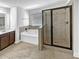 Bathroom features a soaking tub, shower with glass door, and single-sink vanity at 2910 Blake Towers Ln, Buford, GA 30519